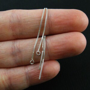 May include: Three silver chain extenders with jump rings and straight ends.
