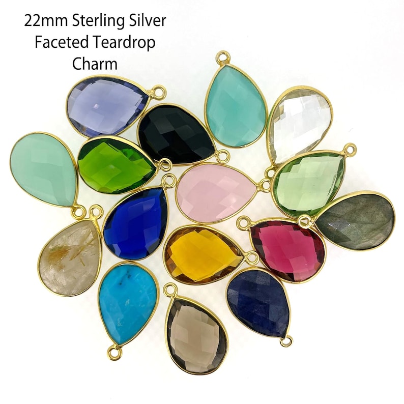An arrangement of different bezel pendants are displayed. The top says 22mm Sterling Silver Faceted Tear drop charm.