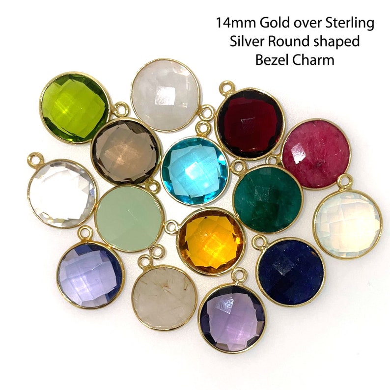 May include: Assortment of 14mm round bezel charms in various colors, including green, white, red, pink, blue, brown, yellow, and purple. The charms are made of gold over sterling silver.