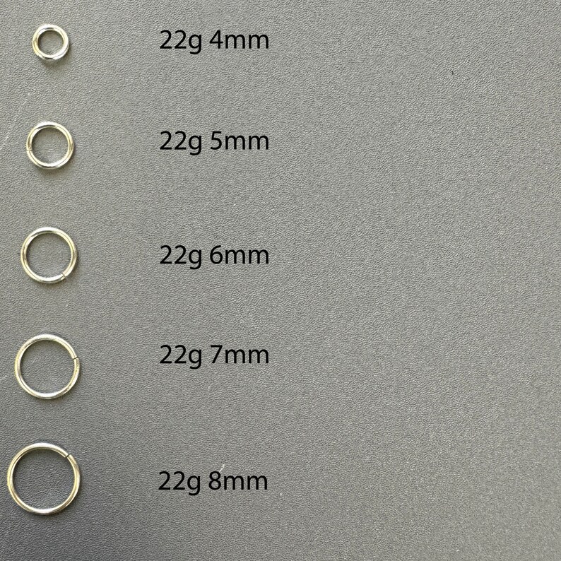 May include: Five silver hoop earrings of different sizes, labeled with their gauge and diameter: 22g 4mm, 22g 5mm, 22g 6mm, 22g 7mm, and 22g 8mm.