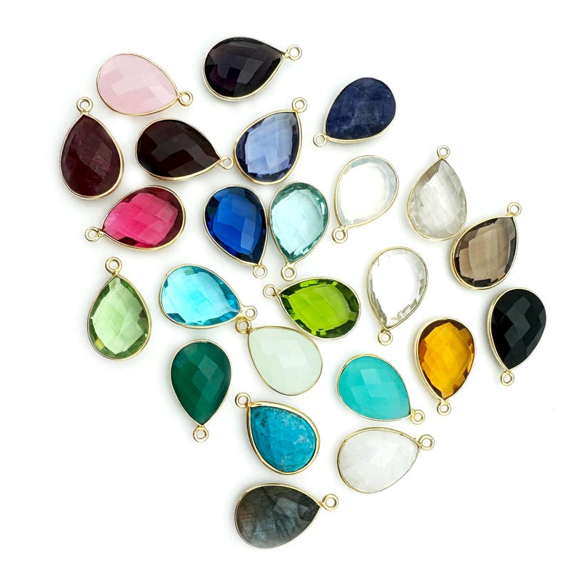 An arrangement of different bezel pendants are displayed.