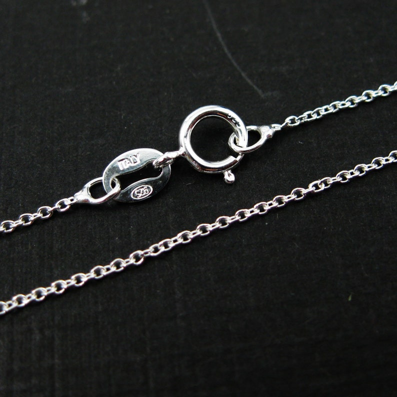 May include: A silver chain necklace with a lobster clasp and a tag that reads "Italy 925".