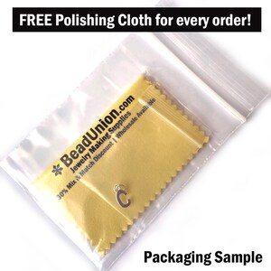 May include: A close-up of a small silver charm in the shape of the letter "C" inside a clear plastic bag with a yellow polishing cloth. The bag has a white zipper and the text "BeadUnion.com Jewelry Making Supplies 30% Mix & Match Discount | Wholesale Available" is printed on the cloth. The text "Packaging Sample" is printed below the bag.