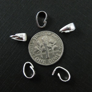 May include: Five silver-toned pendant bails, each with a loop opening, are arranged around a US dime coin. The bails are approximately the same size as the dime.
