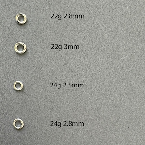 May include: Four silver jump rings in different sizes. The rings are labeled with their gauge and diameter: 22g 2.8mm, 22g 3mm, 24g 2.5mm, and 24g 2.8mm.