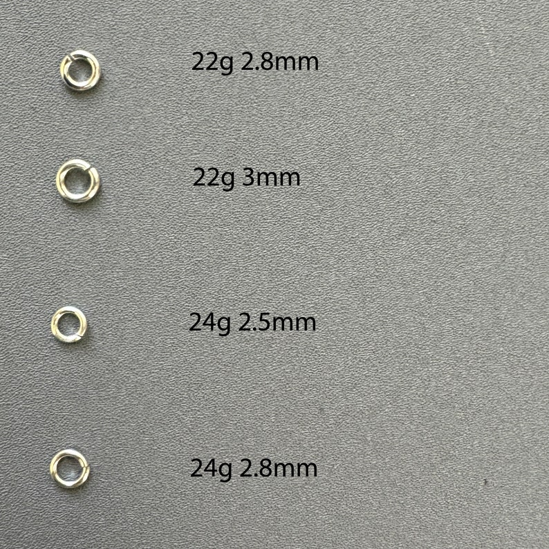May include: Four silver jump rings in different sizes. The rings are labeled with their gauge and diameter: 22g 2.8mm, 22g 3mm, 24g 2.5mm, and 24g 2.8mm.