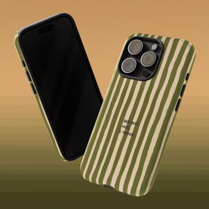 May include: Two phone cases with a green and white striped pattern. One case is angled, revealing the phone's black screen. The other case displays the phone's camera lenses and the text "QUELQUES MOTS D'AMOUR".