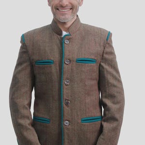 May include: Brown tweed jacket with teal trim and decorative buttons. The jacket features a mandarin collar and two front pockets. A traditional style garment.