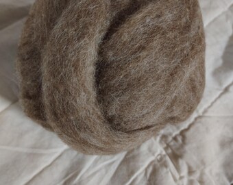 May include: A ball of brown wool fiber, perfect for felting or spinning.