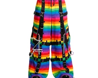 May include: Wide-leg trousers featuring a horizontal rainbow stripe pattern. The pants include black straps, silver-toned metal D-rings, and hanging chains. The text Top Leather Artisan is printed on the left leg. The waist has a drawstring closure.