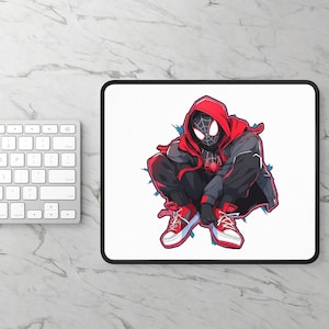 May include: A white rectangular mousepad with a black border featuring a graphic of a superhero in a red hooded jacket, black suit, and red sneakers. The superhero is crouching with a spider emblem on the chest.