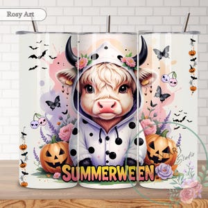 May include: A white tumbler featuring a whimsical design with a cow wearing a polka-dot hoodie, surrounded by pumpkins, butterflies, and the word "SUMMERWEEN". The design includes bats, flowers, and cherries.