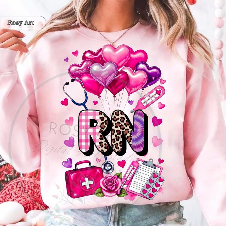 Peut inclure: Sweat-shirt rose clair avec un motif graphique comprenant des ballons en forme de c&oelig;ur, un st&eacute;thoscope, un thermom&egrave;tre et les lettres "RN" dans diff&eacute;rents motifs. Une trousse de premiers secours rose, une rose et un presse-papiers avec des c&oelig;urs compl&egrave;tent le design.
