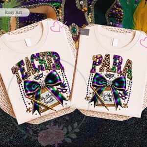 May include: Two cream-colored t-shirts with the words "TEACHER" and "PARA" in leopard print and purple letters. Each shirt features a large green and purple bow, a pencil, and a decorative mask. The shirts are on a woven surface.