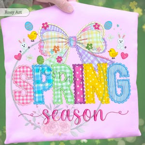 May include: A light pink fabric with the words "SPRING season" in colorful, embroidered letters. The design includes a large bow, Easter eggs, chicks, and bunnies, all in a spring theme. The brand name "Rosy Art" is in the top left corner.
