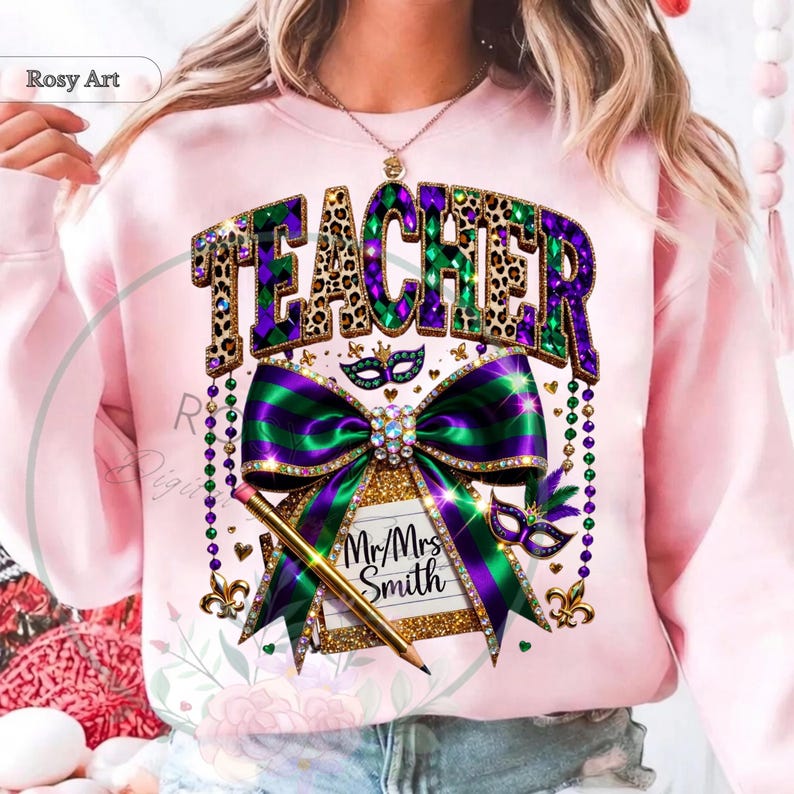 May include: A light pink sweatshirt with a graphic design featuring the word "TEACHER" in leopard print and purple and green colors. A large bow and pencil are also featured in the design, along with the text "Mr/Mrs Smith".