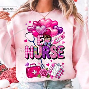 Peut inclure: Sweat-shirt rose clair avec l'inscription "ER NURSE" dans un design color&eacute;. Le motif comprend des ballons en forme de c&oelig;ur, un st&eacute;thoscope, un thermom&egrave;tre, une trousse m&eacute;dicale et un presse-papiers avec des c&oelig;urs. Le design utilise du rose, du violet et d'autres couleurs.