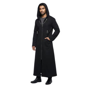May include: A long black hooded coat with a full-length zip and chain detail. The coat has a flowing design with pockets and is worn with black boots.