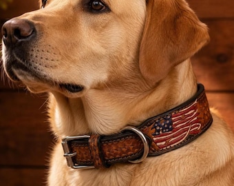 May include: A golden Labrador Retriever wearing a brown leather dog collar. The collar features a woven design and a painted American flag with red, white, and blue colors. A silver metal buckle and ring are visible.