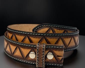 May include: A brown leather belt with a geometric triangle pattern. The belt has a silver buckle and rivets, with white stitching along the edges. The belt is approximately 1.5 inches wide.