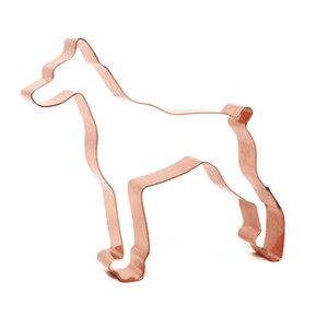 May include: Copper cookie cutter in the shape of a Doberman Pinscher dog.