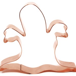 May include: Copper cookie cutter shaped like a ghost with outstretched arms.