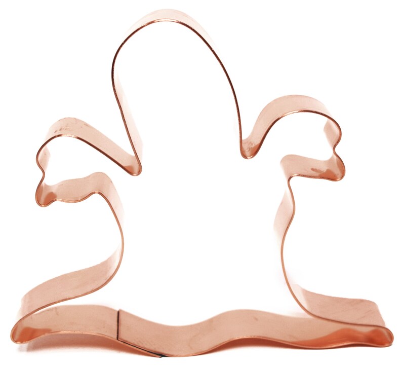 May include: Copper cookie cutter shaped like a ghost with outstretched arms.