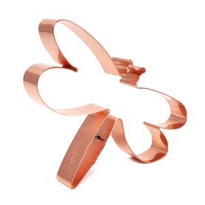 May include: Copper cookie cutter shaped like a dragonfly. The cutter is about 4 inches long and 3 inches wide.