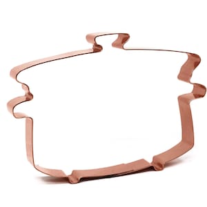 Könnte beinhalten: Ein kupferfarbener Keksausstecher in Form eines Topfes mit Deckel. Der Ausstecher ist zum Ausstechen von Keksen oder anderen Backwaren gedacht.