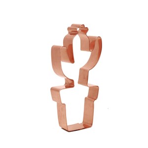 Może przedstawiać: Forma do ciasteczek z miedzi w kształcie kaktusa w doniczce.