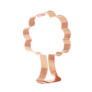 May include: A copper-colored cookie cutter shaped like a tree with a simple, rounded trunk and a rounded, scalloped crown.