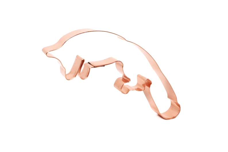 May include: A copper-colored cookie cutter shaped like a platypus. The cutter is designed to create a detailed outline of a platypus.