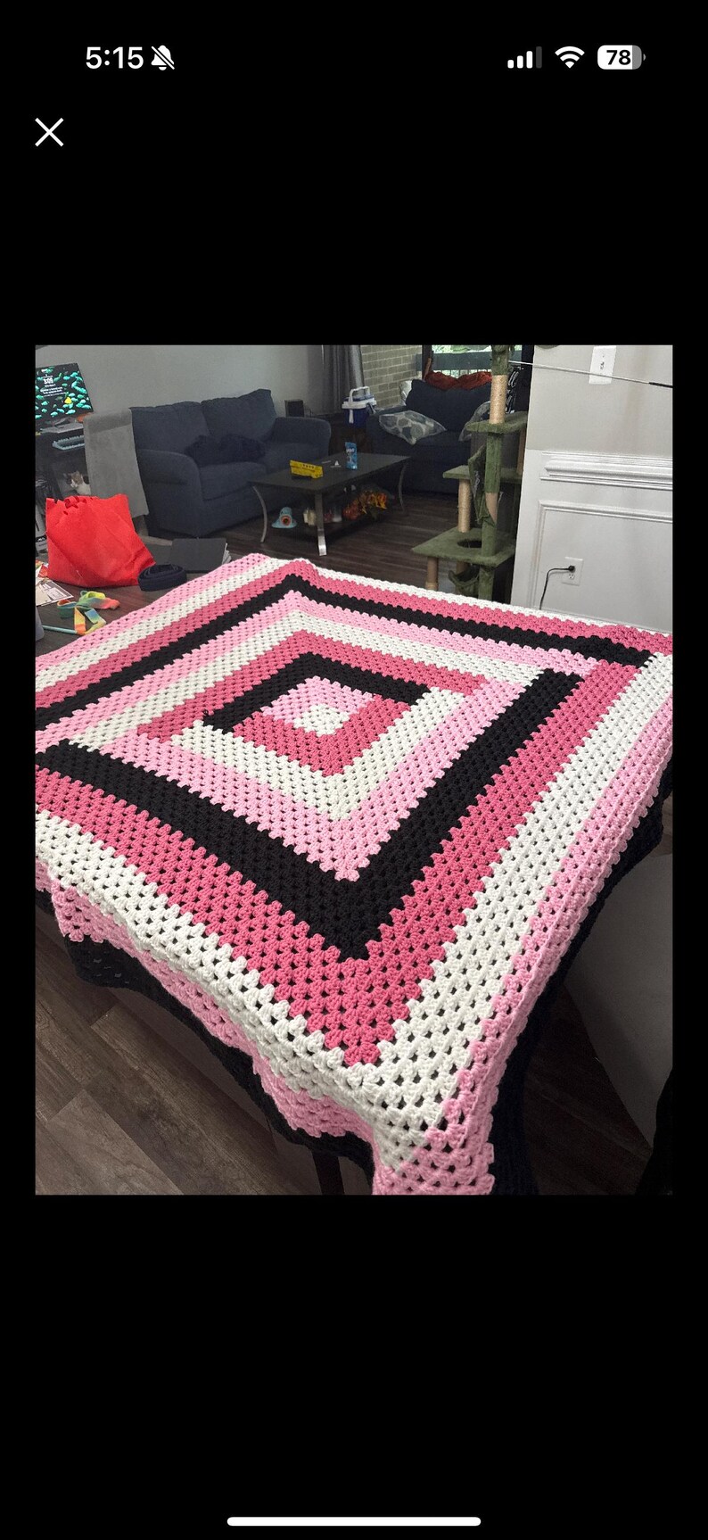 May include: A square crochet blanket featuring a geometric pattern of concentric diamonds. The design consists of alternating bands of light pink, white, dark pink, and black yarn, worked in a traditional granny square stitch construction.
