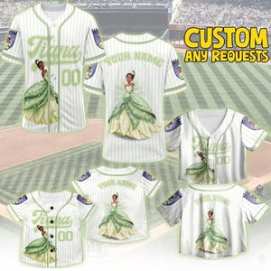 May include: White baseball jerseys with green pinstripes and accents. The jerseys feature a princess in a green dress, the name "Tiana" and the number "00". The text "CUSTOM ANY REQUESTS" is in yellow.