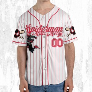 May include: White baseball jersey with red pinstripes, featuring the text "Spiderman Miles Morales" in red script. Includes a graphic of Spiderman and the number "00". The sleeves have a baseball bat and Spiderman logo.