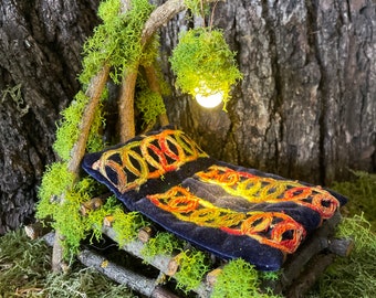 Woodland Fairy Bed with comforter, pillow, and hanging battery light.