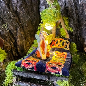 Woodland Fairy Bed with comforter, pillow, and hanging battery light.