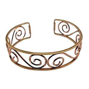 May include: A gold-toned cuff bracelet with an open design. The bracelet features a series of swirling, scroll-like patterns. The metal has a slightly hammered texture, adding visual interest to the jewelry.