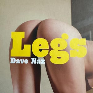 May include: A photograph with the word "Legs" in large yellow letters, and the name "Dave Naz" in white below. The image depicts a person's legs and buttocks, set against a neutral background.