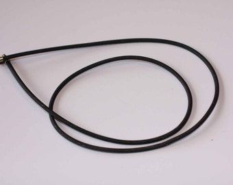 May include: A black rubber necklace with a silver clasp.