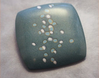 teal pin with "bubbles" pattern