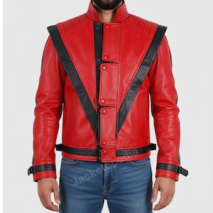 May include: A red leather jacket with black accents. The jacket features a stand-up collar, shoulder epaulets, and black stripes across the chest and sleeves. It has a button-up front and adjustable straps at the waist and wrists.