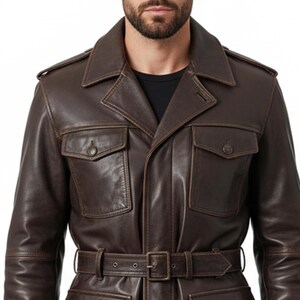 May include: A brown leather jacket with a belted waist and two front pockets. The jacket has a classic design with a collared neckline and shoulder epaulets. The leather appears to have a distressed finish.