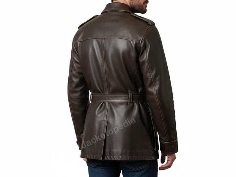 May include: A brown leather jacket with a belted waist and buttoned cuffs. The jacket has a classic trench coat design with shoulder epaulets and a notched collar. The back view shows the jacket's tailored fit and details.