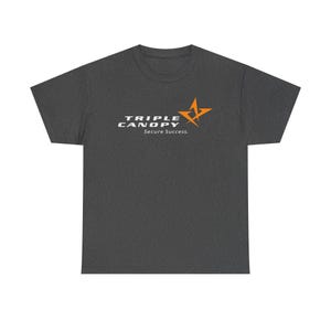 May include: Dark gray t-shirt with the text "TRIPLE CANOPY Secure Success" in white and an orange starburst logo. The shirt is made of a soft material and has a crew neck.