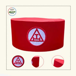 May include: A red fez hat with a white embroidered emblem featuring a triangle and a horizontal bar. The hat is cylindrical and has a smooth texture. The emblem is centered on the front of the hat.