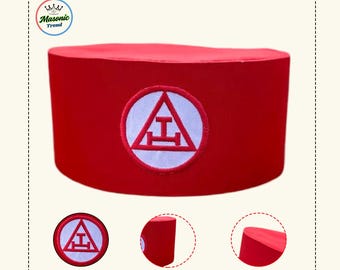 May include: A red fez hat with a white embroidered emblem featuring a triangle and a horizontal bar. The hat is cylindrical and has a smooth texture. The emblem is centered on the front of the hat.