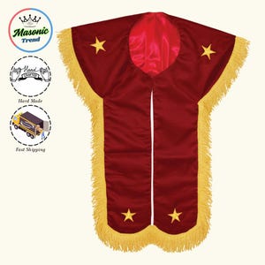 May include: A burgundy ceremonial robe with gold fringe and embroidered gold stars. The robe has a red satin lining and is open in the front. The image also includes the text "Masonic Trend", "Hand Crafted", and "Fast Shipping".