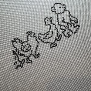 May include: A cross-stitch design featuring a line of three animals: a chicken, a duck, and a bear. The animals are stitched in black thread on a light gray fabric with a woven texture. The design is simple and charming.