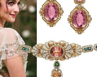 May include: Elegant jewelry set featuring a necklace and matching earrings. The set includes large pink oval gemstones, surrounded by smaller diamonds and set in gold. The earrings have a drop design, and the necklace has a pendant with multiple gemstones.
